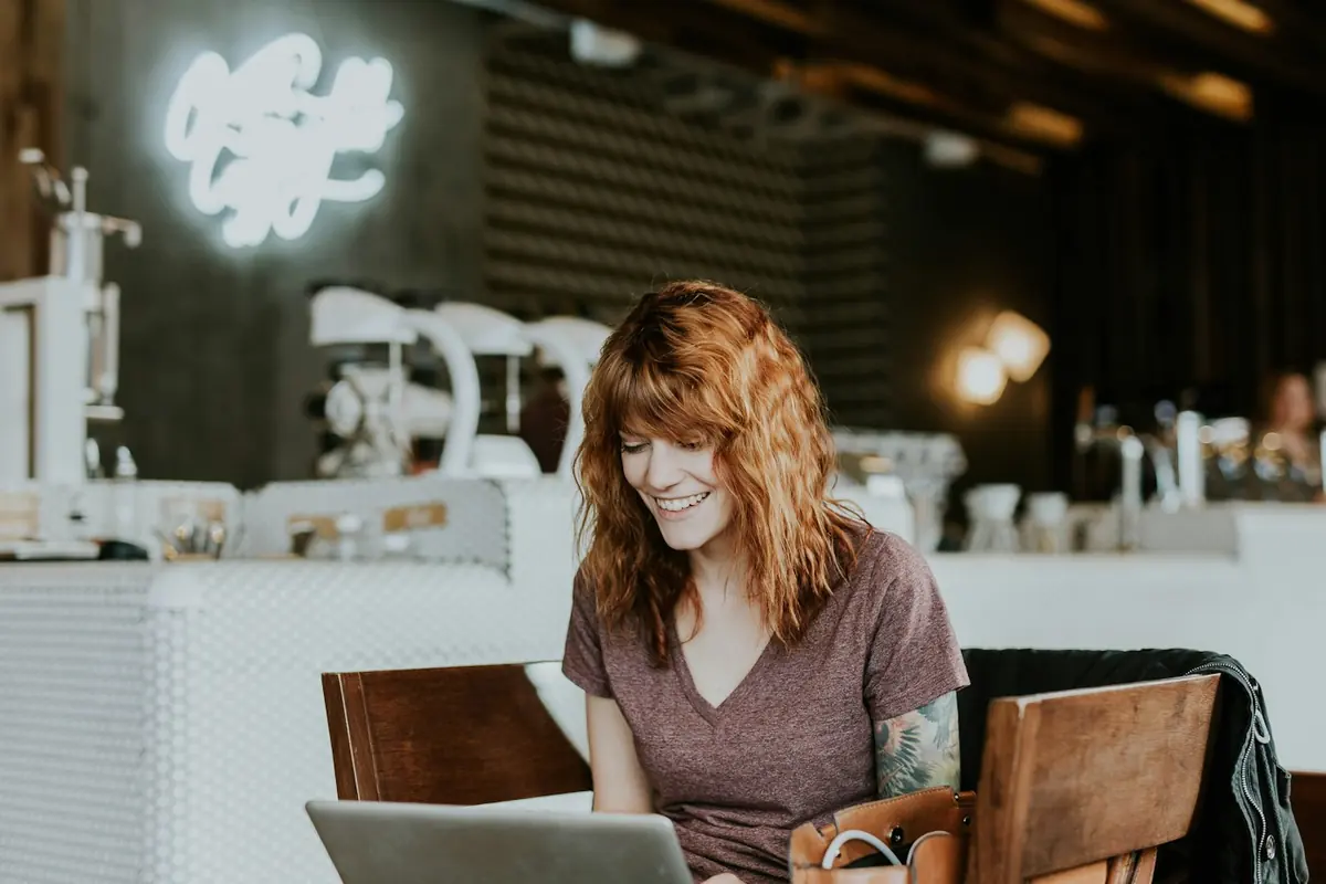 Frau arbeitet an der Café-Theke am Laptop